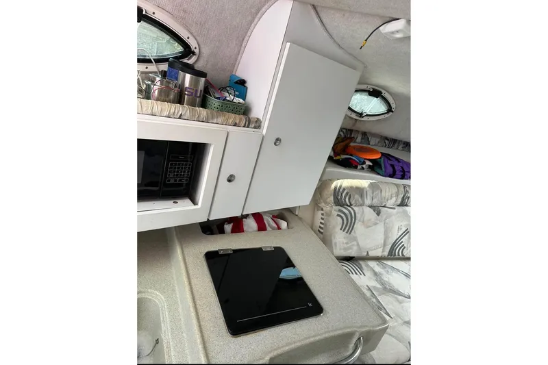 Slide: The Image of Interior of 2000 Wellcraft 290 Coastal boat with kitchenette and seating area. - 2