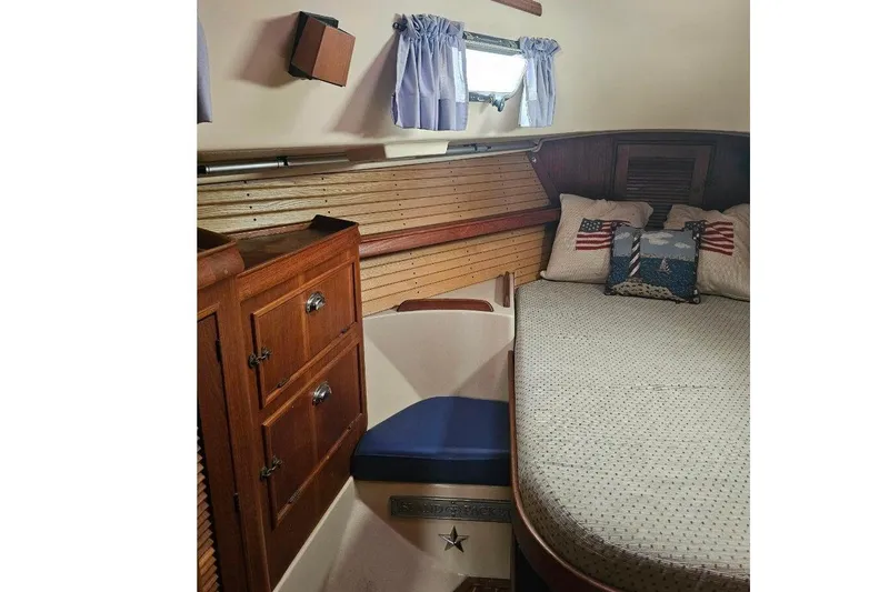 Slide: The Image of Cozy cabin interior of 1999 Island Packet 350 sailboat with nautical decor. - 11