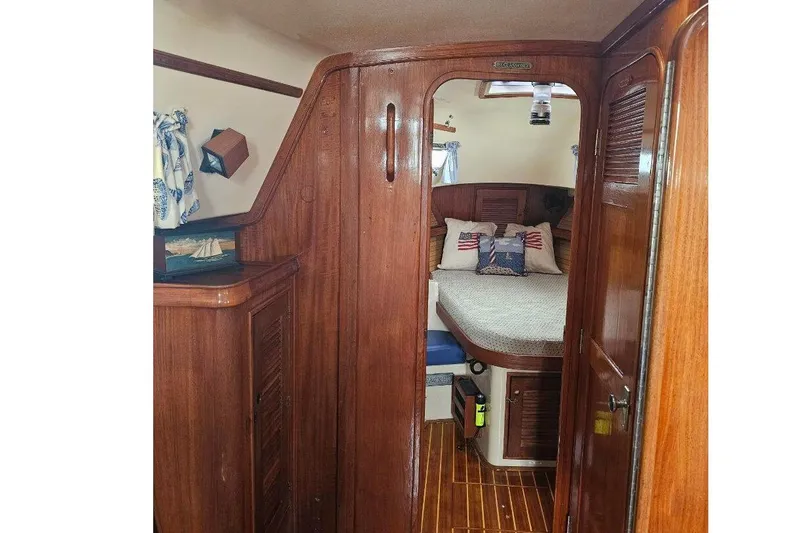 Slide: The Image of 1999 Island Packet 350 yacht interior with wooden finish and cozy cabin. - 14