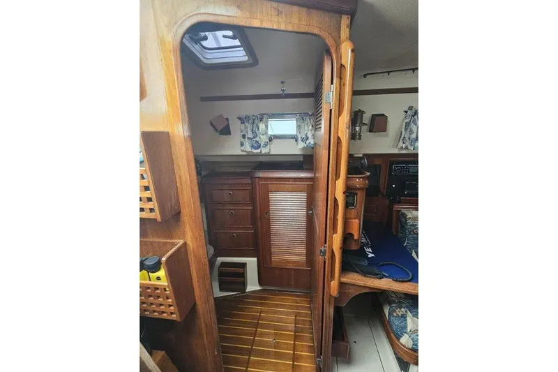 Slide: The Image of Interior of 1999 Island Packet 350 sailboat with wooden cabinetry and nautical decor. - 17