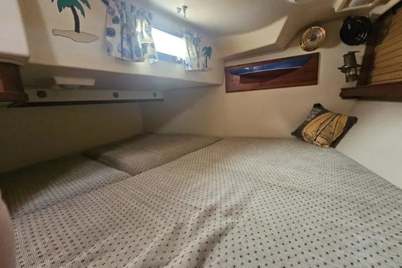 Slide: The Image of Cozy cabin interior of a 1999 Island Packet 350 sailboat with nautical decor. - 19