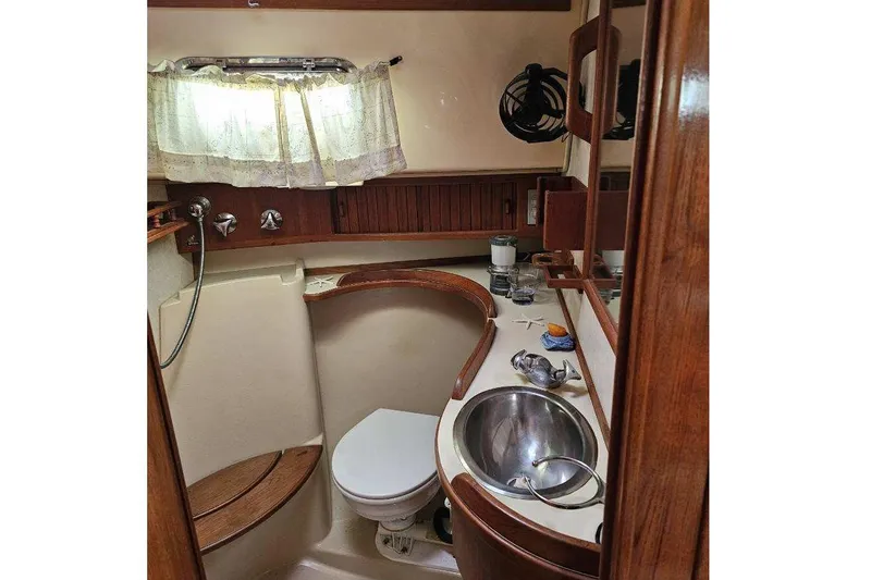 Slide: The Image of 1999 Island Packet 350 yacht bathroom with sink, toilet, and wooden accents. - 20