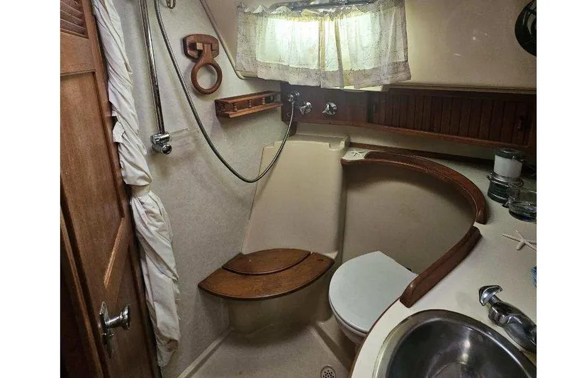 Slide: The Image of 1999 Island Packet 350 yacht bathroom with shower, toilet, and sink. - 21