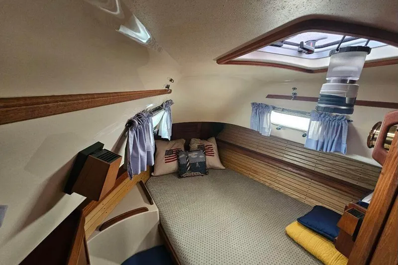 Slide: The Image of Cozy cabin interior of 1999 Island Packet 350 sailboat with nautical decor and soft lighting. - 28