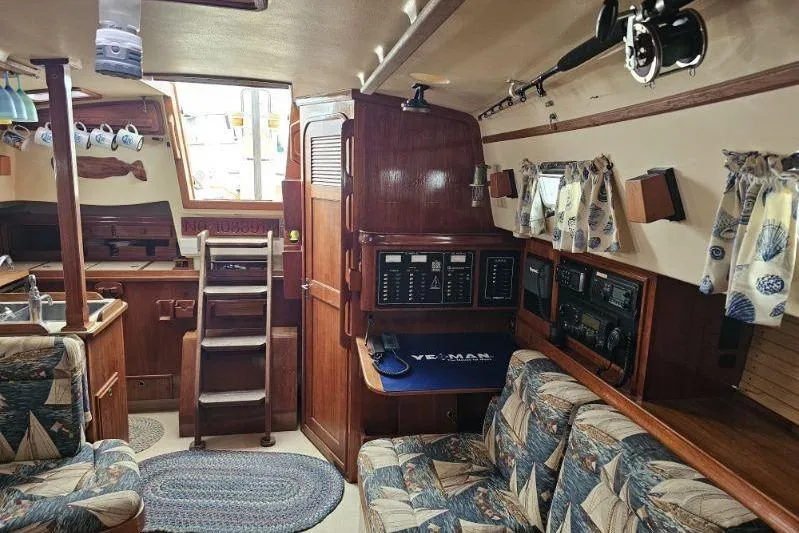 Slide: The Image of Interior of a 1999 Island Packet 350 sailboat with cozy seating and nautical decor. - 3