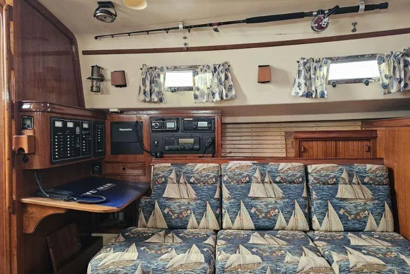 Slide: The Image of 1999 Island Packet 350 yacht interior with nautical-themed upholstery and navigation equipment. - 6