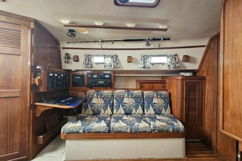 Slide: The Image of Interior of 1999 Island Packet 350 sailboat with nautical-themed upholstery and wooden cabinetry. - 7