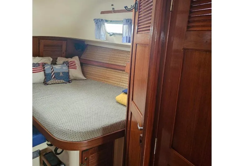 Slide: The Image of Cozy cabin interior of 1999 Island Packet 350 sailboat with wooden finish and nautical decor. - 9