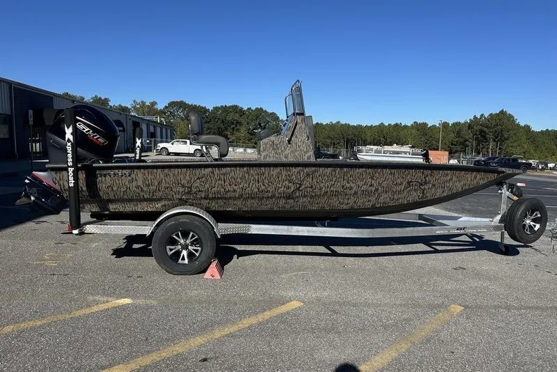 The Image of 2026 Xpress H20B Bay boat on trailer, parked outside a building. - 0