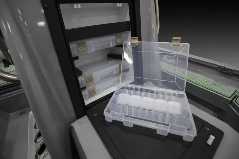 Slide: The Image of Open storage compartment with tackle boxes in 2026 Xpress H20B Bay boat. - 13