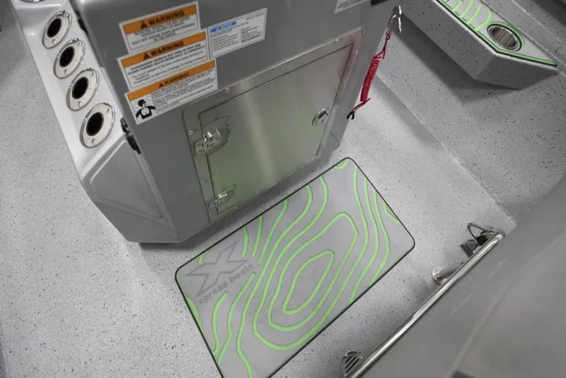 Slide: The Image of Interior of 2026 Xpress H20B Bay boat with storage compartment and custom mat. - 21