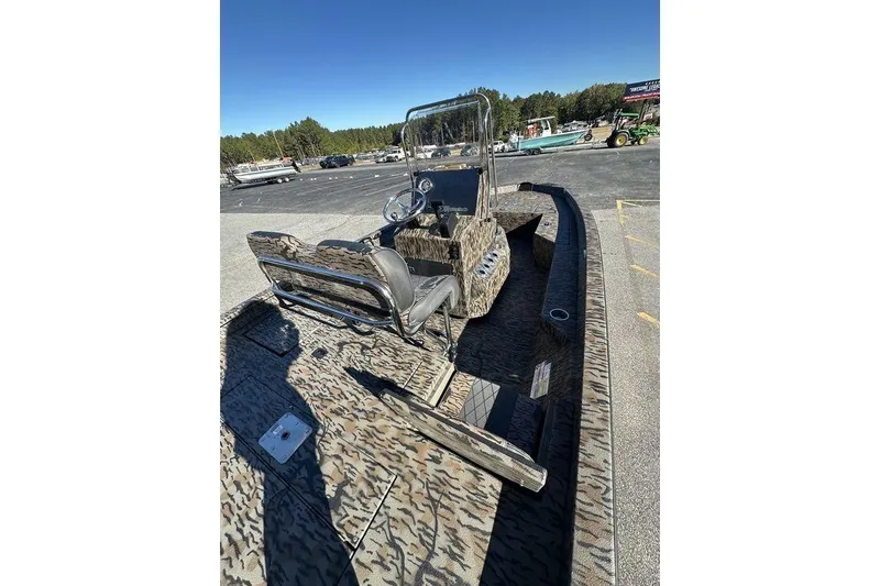 Slide: The Image of 2026 Xpress H20B Bay boat with camouflage design in a parking lot. - 3