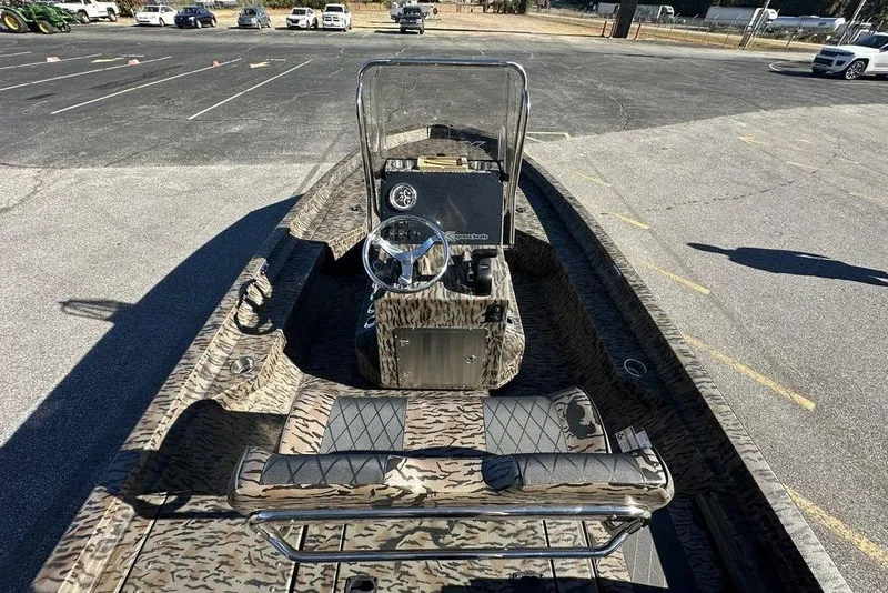 Slide: The Image of 2026 Xpress H20B Bay boat with camouflage design in a parking lot. - 5