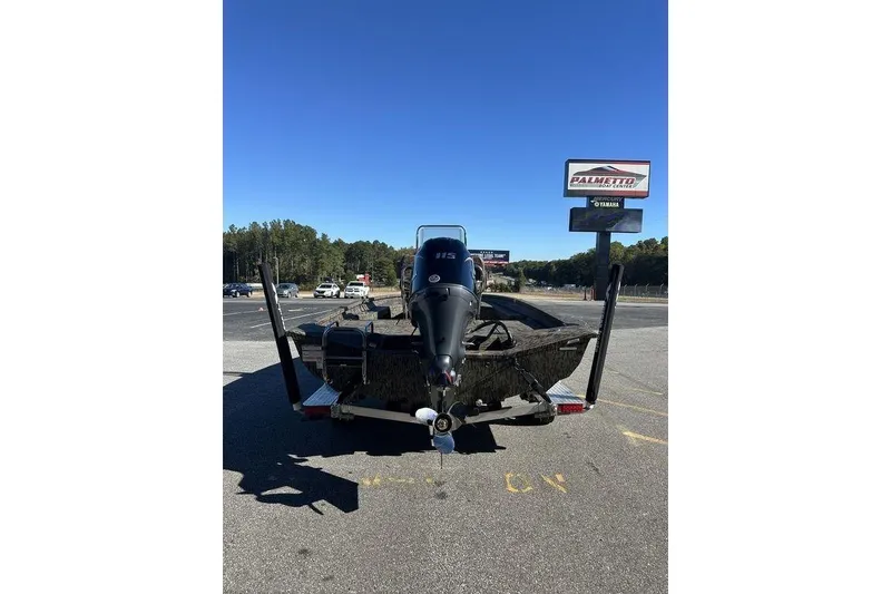 Slide: The Image of 2026 Xpress H20B Bay boat with Yamaha engine, parked outdoors on a sunny day. - 6