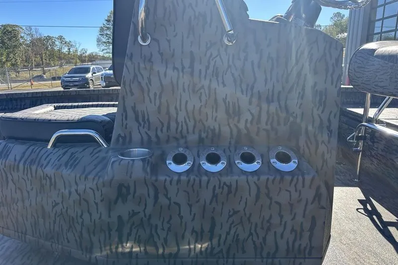 Slide: The Image of 2026 Xpress H20B Bay boat interior with camouflage design and rod holders. - 9
