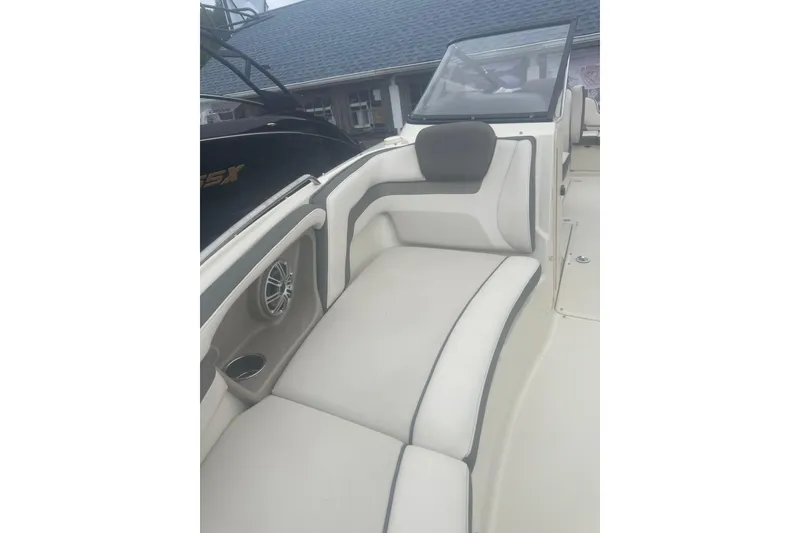 Slide: The Image of 2015 Yamaha Boats 242 Limited interior with cushioned seating and speaker. - 11