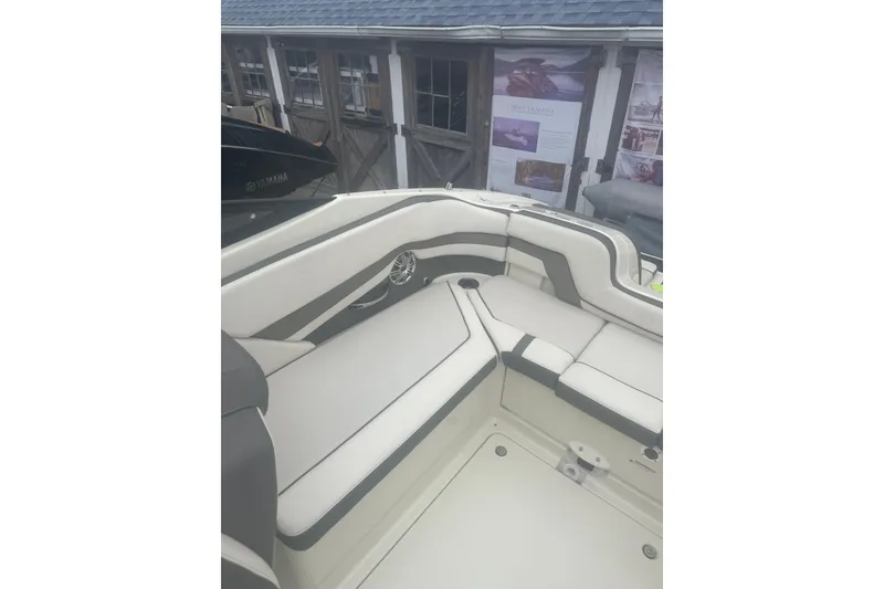 Slide: The Image of 2015 Yamaha Boats 242 Limited interior seating with white and gray upholstery. - 15