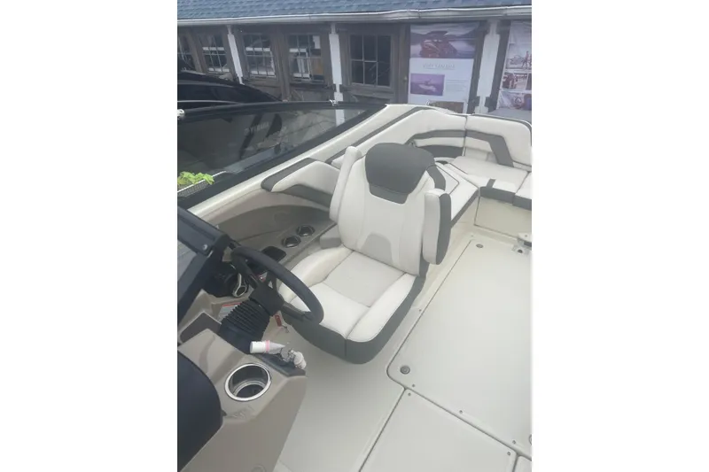 Slide: The Image of 2015 Yamaha Boats 242 Limited interior with steering wheel and seating area. - 17