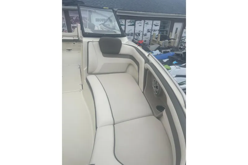 Slide: The Image of 2015 Yamaha Boats 242 Limited interior seating with beige upholstery and speaker. - 23