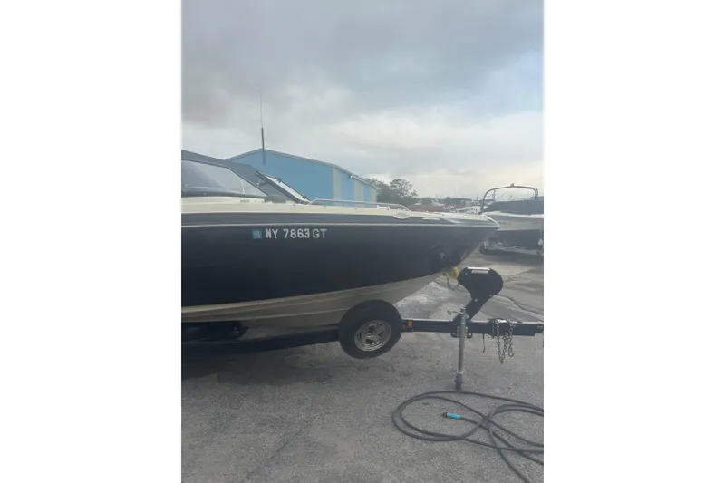Slide: The Image of 2015 Yamaha Boats 242 Limited on trailer, parked outdoors under cloudy sky. - 5