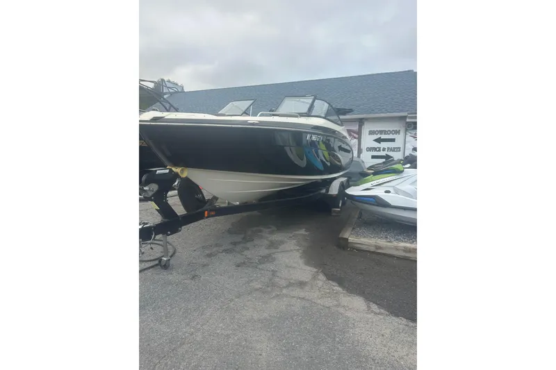 Slide: The Image of 2015 Yamaha Boats 242 Limited on trailer outside showroom. - 6