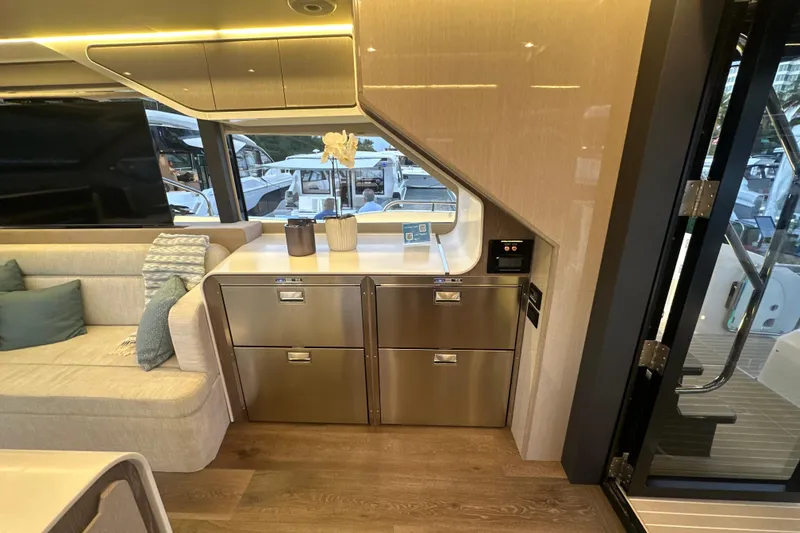 Slide: The Image of Luxurious interior of 2026 Cruisers Yachts 57 Fly with modern cabinetry and seating. - 14