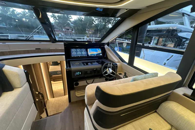 Slide: The Image of Luxurious interior of 2026 Cruisers Yachts 57 Fly with modern helm and navigation displays. - 18