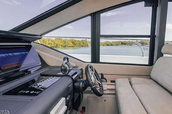 Slide: The Image of 2026 Cruisers Yachts 57 Fly on open water, showcasing sleek design and modern features. - 2