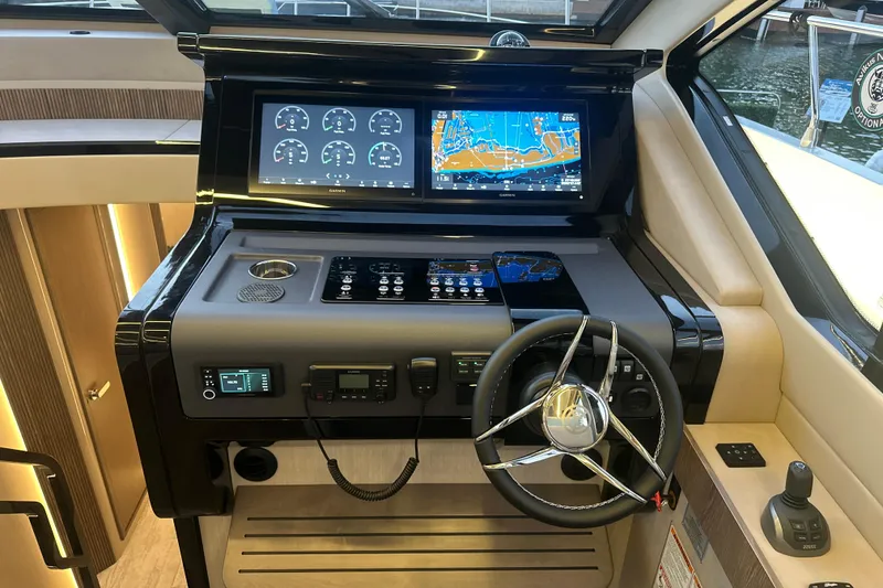 Slide: The Image of 2026 Cruisers Yachts 57 Fly helm with advanced navigation displays and controls. - 20
