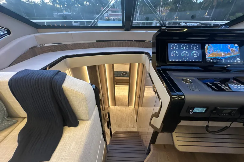 Slide: The Image of Luxurious interior of 2026 Cruisers Yachts 57 Fly with modern navigation displays. - 21