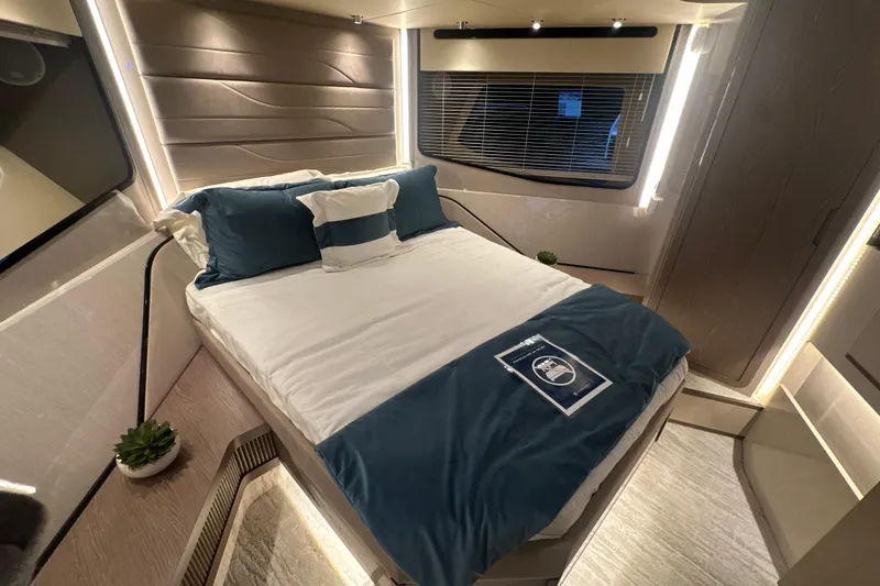 Slide: The Image of Luxurious bedroom interior of 2026 Cruisers Yachts 57 Fly with modern design and ambient lighting. - 28