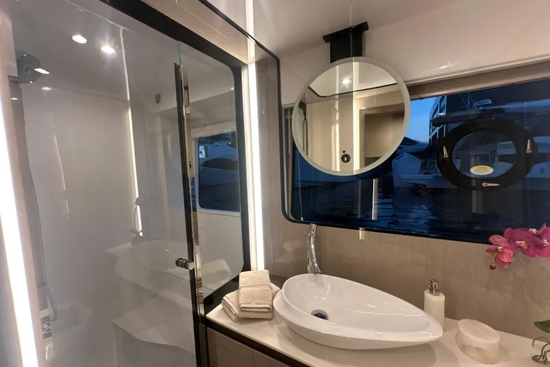 Slide: The Image of Luxurious bathroom interior of 2026 Cruisers Yachts 57 Fly with modern fixtures and elegant design. - 32