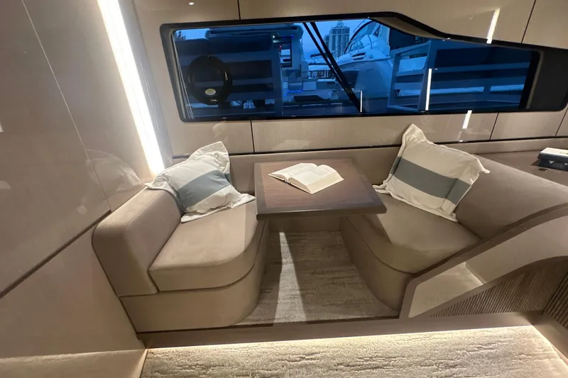 Slide: The Image of Luxurious interior of 2026 Cruisers Yachts 57 Fly with cozy seating and open book. - 36