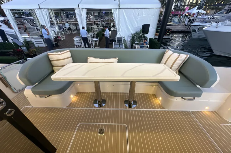 Slide: The Image of Luxurious seating area on 2026 Cruisers Yachts 57 Fly, featuring elegant cushions and table. - 48