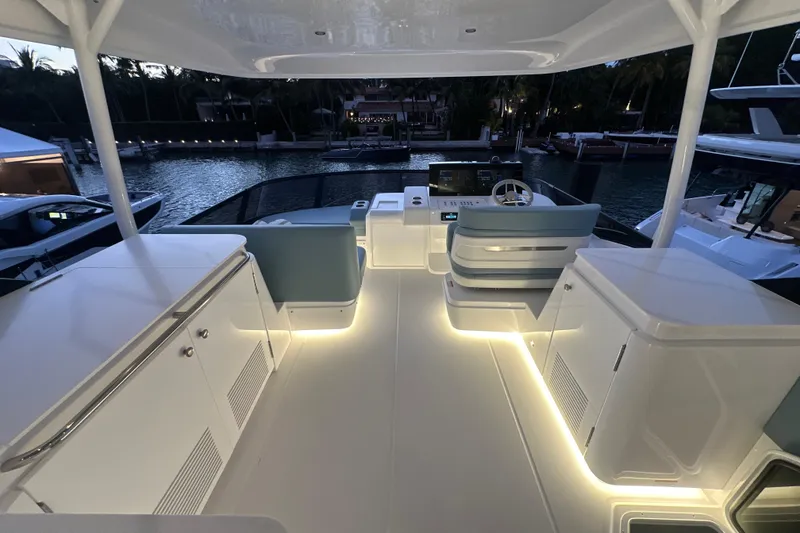 Slide: The Image of Luxurious 2026 Cruisers Yachts 57 Flybridge with illuminated deck and modern helm station. - 53