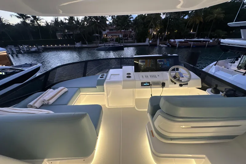 Slide: The Image of Luxurious 2026 Cruisers Yachts 57 Fly bridge with modern helm and seating at sunset. - 57