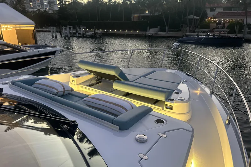 Slide: The Image of Luxurious 2026 Cruisers Yachts 57 Fly with elegant deck seating at sunset. - 61
