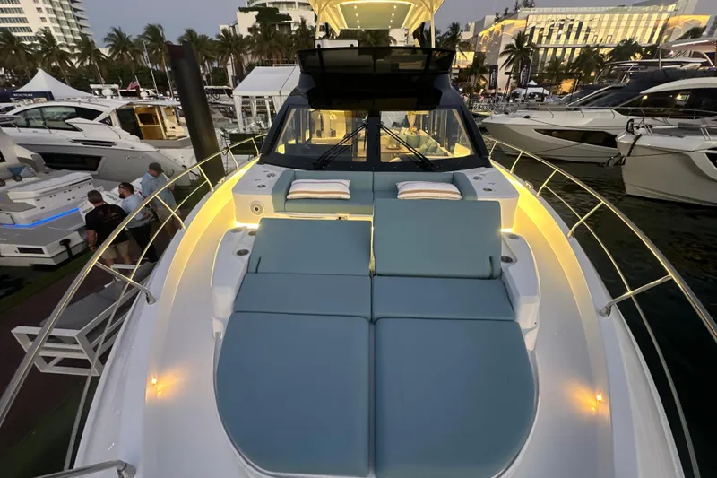 Slide: The Image of Luxurious 2026 Cruisers Yachts 57 Fly with elegant deck seating at a marina. - 63