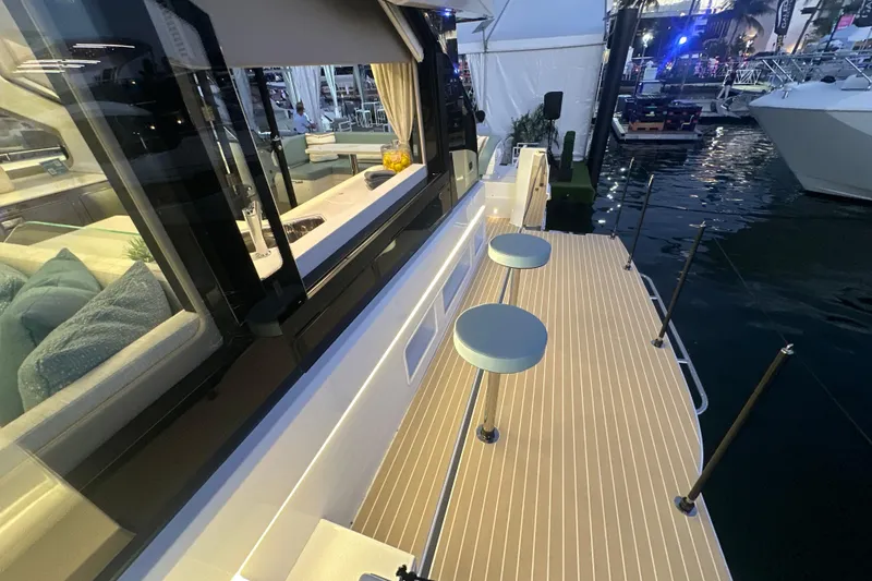 Slide: The Image of 2026 Cruisers Yachts 57 Fly, elegant deck view with modern seating and waterfront ambiance. - 65