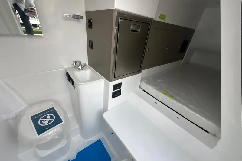 Slide: The Image of 2026 Cruisers Yachts 57 Fly interior with compact bathroom and storage. - 67