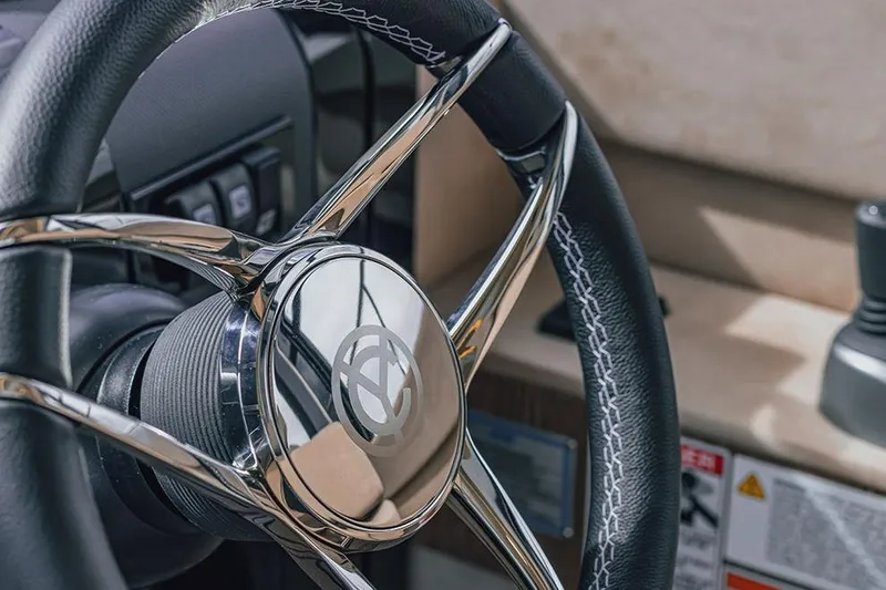 Slide: The Image of Manufacturer Provided Image: Steering wheel of 2026 Cruisers Yachts 57 Fly, featuring sleek chrome and leather design. - 3