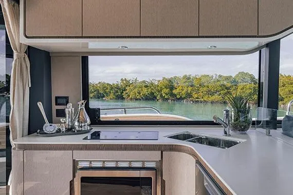 Slide: The Image of Manufacturer Provided Image: Luxurious kitchen interior of 2026 Cruisers Yachts 57 Fly with scenic water view. - 6