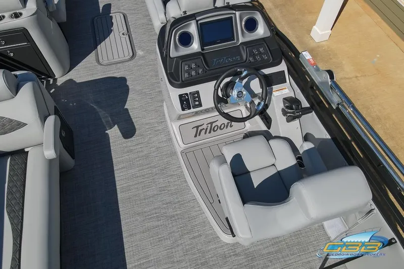 Slide: The Image of 2026 JC 25 Neptoon LG boat interior with steering console and seating. - 18