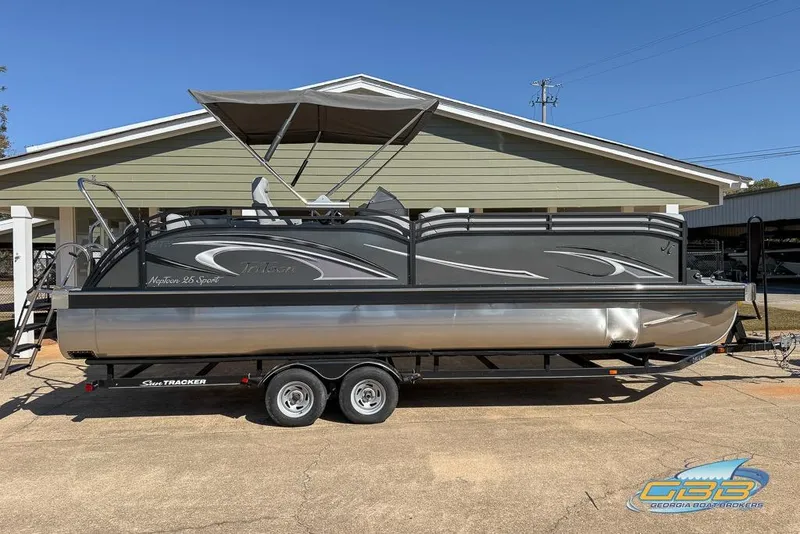Slide: The Image of 2026 JC 25 Neptoon LG pontoon boat on trailer, parked outdoors. - 42