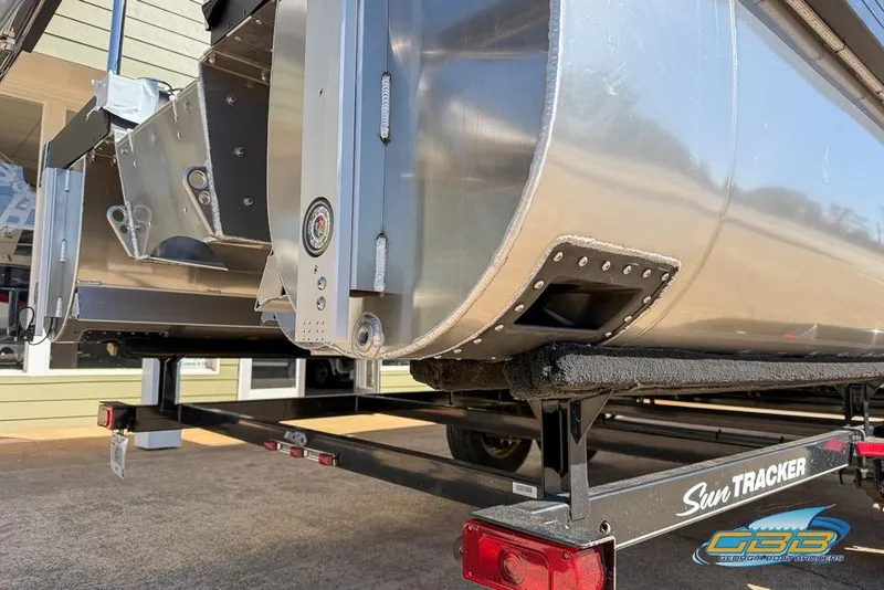 Slide: The Image of 2026 JC 25 Neptoon LG pontoon boat on Sun Tracker trailer, close-up view. - 46