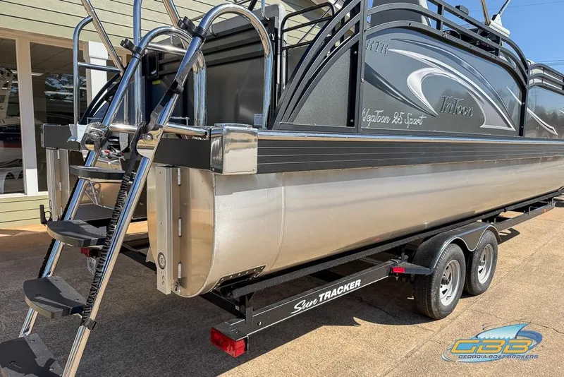 Slide: The Image of 2026 JC 25 Neptoon LG pontoon boat on trailer, featuring sleek design and sturdy ladder. - 47
