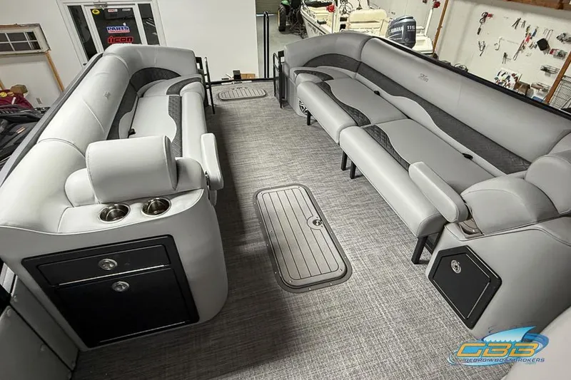 Slide: The Image of 2026 JC 25 Neptoon LG pontoon boat interior with gray seating and storage compartments. - 56