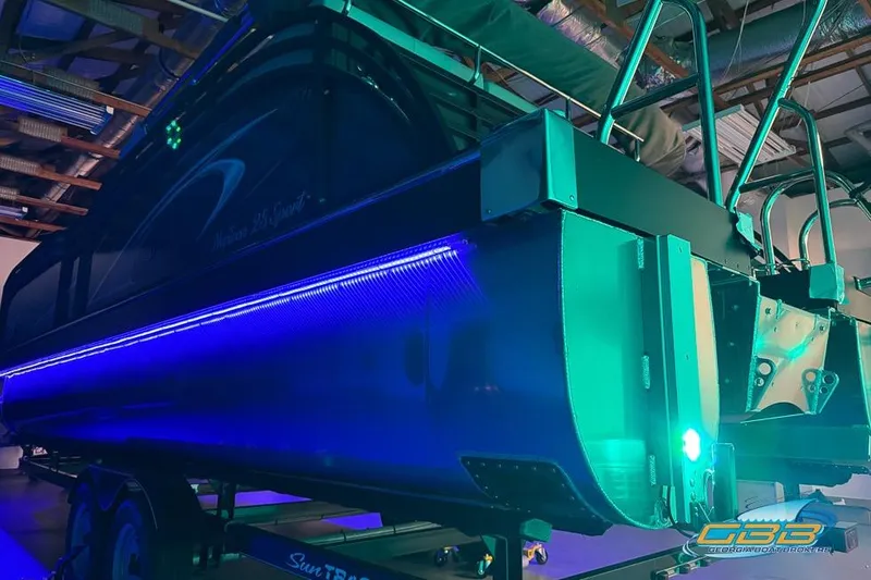 Slide: The Image of 2026 JC 25 Neptoon LG pontoon boat with vibrant blue and green LED lighting. - 63
