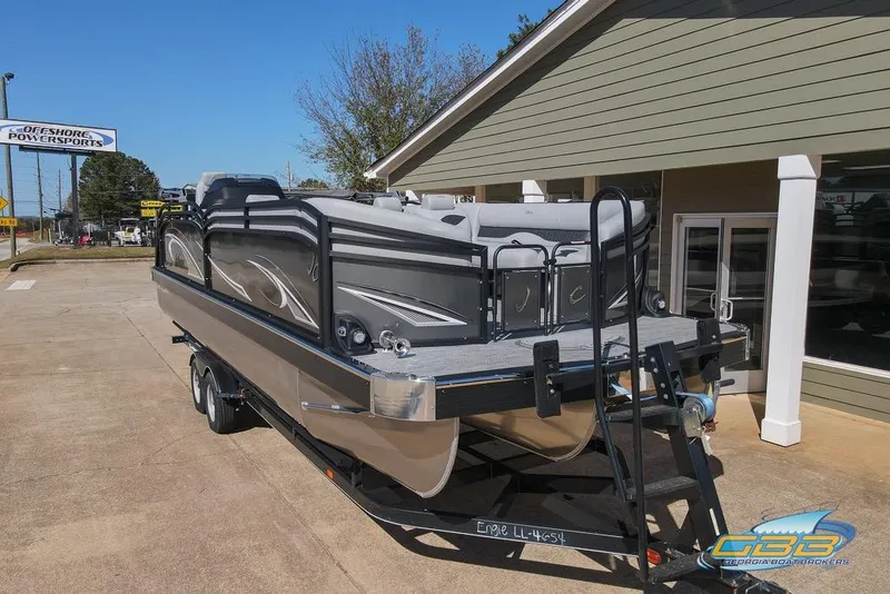 Slide: The Image of 2026 JC 25 Neptoon LG pontoon boat on trailer, parked outside showroom. - 14