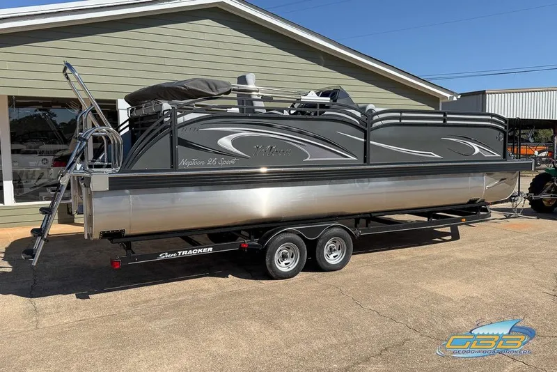 Slide: The Image of 2026 JC 25 Neptoon LG pontoon boat on trailer, parked outside a building. - 21